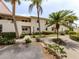 Charming condo featuring lush landscaping and a well-maintained exterior at 758 Village Cir # 106, Venice, FL 34292