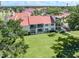 Back of condo with large windows overlooking yard at 758 Village Cir # 106, Venice, FL 34292