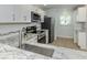 Updated kitchen showcases stainless steel appliances, granite counters, and white cabinets at 758 Village Cir # 106, Venice, FL 34292