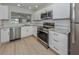 Stylish kitchen with stainless steel appliances, granite countertops, and ample cabinet space at 758 Village Cir # 106, Venice, FL 34292