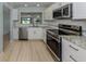 Kitchen area with stainless steel appliances and granite countertops at 758 Village Cir # 106, Venice, FL 34292