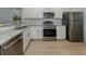Well-appointed kitchen featuring stainless steel appliances and granite countertops at 758 Village Cir # 106, Venice, FL 34292