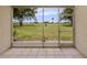 Screened-in lanai showcasing serene views of the meticulously kept lawn at 758 Village Cir # 106, Venice, FL 34292