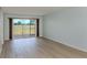Bright living room featuring a large sliding glass door and wood flooring at 758 Village Cir # 106, Venice, FL 34292