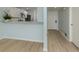 Open floorplan with an adjacent kitchen with a breakfast bar and modern wood floors at 758 Village Cir # 106, Venice, FL 34292