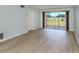 Bright living room featuring wood floors and sliding glass doors with golf course view at 758 Village Cir # 106, Venice, FL 34292