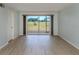 Bright living room boasts modern flooring and scenic views of the lush outdoors at 758 Village Cir # 106, Venice, FL 34292