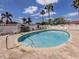 Community pool with clear blue water and palm trees, surrounded by lounge chairs and white picket fence at 758 Village Cir # 106, Venice, FL 34292