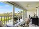Screened-in balcony featuring outdoor dining with a scenic view of the lake at 821 Waterside Dr # 205, Venice, FL 34285