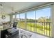 Comfortable lanai featuring a workspace and views of the lush landscaping and lake at 821 Waterside Dr # 205, Venice, FL 34285