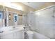 Bathroom featuring a large mirror, shower with glass doors, and a single sink at 821 Waterside Dr # 205, Venice, FL 34285