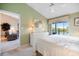 Bedroom featuring a view of the lake, a king bed, and a white dresser beneath a mirror at 821 Waterside Dr # 205, Venice, FL 34285