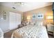 Bedroom featuring a sliding door closet, side chair, and a window providing lots of light at 821 Waterside Dr # 205, Venice, FL 34285