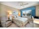 Bedroom with a large window providing natural light, side chair, and a view of the exterior at 821 Waterside Dr # 205, Venice, FL 34285