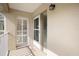 Cozy condo front entrance with storm door and welcoming porch at 821 Waterside Dr # 205, Venice, FL 34285