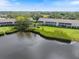 Wonderful back exterior of condo complex with stunning lake views and lush landscaping at 821 Waterside Dr # 205, Venice, FL 34285