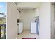 Convenient, in-unit laundry room with washer, dryer, and storage cabinets at 821 Waterside Dr # 205, Venice, FL 34285