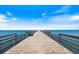 Scenic view of the pier stretching out into the tranquil, turquoise water at 821 Waterside Dr # 205, Venice, FL 34285