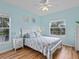 Cozy bedroom features a queen bed, light blue walls, ceiling fan, and two windows at 904 Addington Ct # 204, Venice, FL 34293