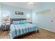 Bedroom with wood floors, ceiling fan, blue walls, and side tables with lamps at 904 Addington Ct # 204, Venice, FL 34293