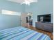 Bedroom featuring wood-look floors, a TV, and a view into another room at 904 Addington Ct # 204, Venice, FL 34293
