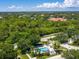 Beautiful aerial view of a community pool surrounded by green trees at 904 Addington Ct # 204, Venice, FL 34293