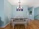 Dining area with table, chairs and bench with view to a house plant, and stairway at 904 Addington Ct # 204, Venice, FL 34293