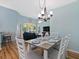 Bright dining area featuring modern light fixture and seating for six, creating an inviting space at 904 Addington Ct # 204, Venice, FL 34293