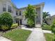 Charming two-story condo featuring lush landscaping, inviting entrance, and classic architectural details at 904 Addington Ct # 204, Venice, FL 34293