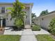 Attractive home exterior with lush landscaping, a front staircase, and a walkway to a detached garage at 904 Addington Ct # 204, Venice, FL 34293