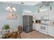 Bright kitchen with white cabinets, stainless steel refrigerator, tile floors, and breakfast area at 904 Addington Ct # 204, Venice, FL 34293