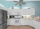 Bright kitchen features white cabinetry, stainless appliances, and nautical decor above the cabinets at 904 Addington Ct # 204, Venice, FL 34293