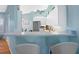 Bright kitchen with bar seating overlooking stainless steel refrigerator and white cabinets at 904 Addington Ct # 204, Venice, FL 34293