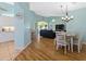 Open-concept living room with wood floors, dining area, and view to the lanai at 904 Addington Ct # 204, Venice, FL 34293