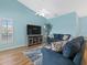 Inviting living room with large TV, comfortable seating, and view of the outdoors at 904 Addington Ct # 204, Venice, FL 34293