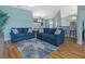 Spacious living room with two sofas, wood flooring, and open access to the dining area at 904 Addington Ct # 204, Venice, FL 34293