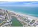 Wide-angle aerial view showcasing beachfront condos, a marina, and the breathtaking ocean at 950 Tarpon Center Dr # 504, Venice, FL 34285