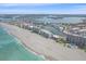 Stunning aerial view of beachfront condos, marina, and sandy shore of the Gulf of Mexico at 950 Tarpon Center Dr # 504, Venice, FL 34285