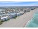 Gorgeous aerial view of beachfront condominiums, the sandy shore and blue-green Gulf at 950 Tarpon Center Dr # 504, Venice, FL 34285