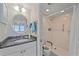 Bathroom with granite countertop, modern fixtures, and a walk-in shower equipped with accessibility features at 950 Tarpon Center Dr # 504, Venice, FL 34285
