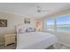Bright bedroom featuring ocean views, a white bed, and neutral tones, creating a relaxing coastal retreat at 950 Tarpon Center Dr # 504, Venice, FL 34285