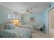 Relaxing bedroom featuring twin beds, coastal decor, and ample natural light for a serene getaway at 950 Tarpon Center Dr # 504, Venice, FL 34285