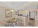 Dining room with view of the kitchen and entry door at 950 Tarpon Center Dr # 504, Venice, FL 34285