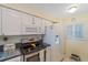 Bright kitchen featuring white appliances, ample cabinet space, and natural light at 950 Tarpon Center Dr # 504, Venice, FL 34285