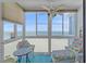 Relaxing sunroom with a seating area and a panoramic view of the beach at 950 Tarpon Center Dr # 504, Venice, FL 34285
