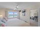 Bedroom with a view of the ocean, ceiling fan, closet, and open access to the living room at 950 Tarpon Center Dr # 504, Venice, FL 34285