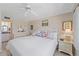 Bright bedroom featuring ocean views, a white bed, and neutral tones, creating a relaxing coastal retreat at 950 Tarpon Center Dr # 504, Venice, FL 34285