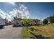 View of home and lawn with parking for cars and boats at 971 Leeward Rd, Venice, FL 34293