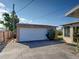 Exterior shot of the detached garage and the connecting building with a sliding glass door at 971 Leeward Rd, Venice, FL 34293