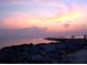 Scenic sunset over a rocky coastline where silhouettes of people enjoy the view at 971 Leeward Rd, Venice, FL 34293